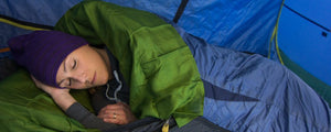 woman sleeping into a tent