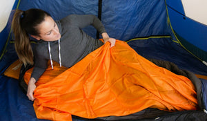 getting into the orange sleeping bag