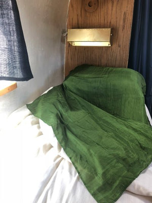 green sleeping bag in air stream